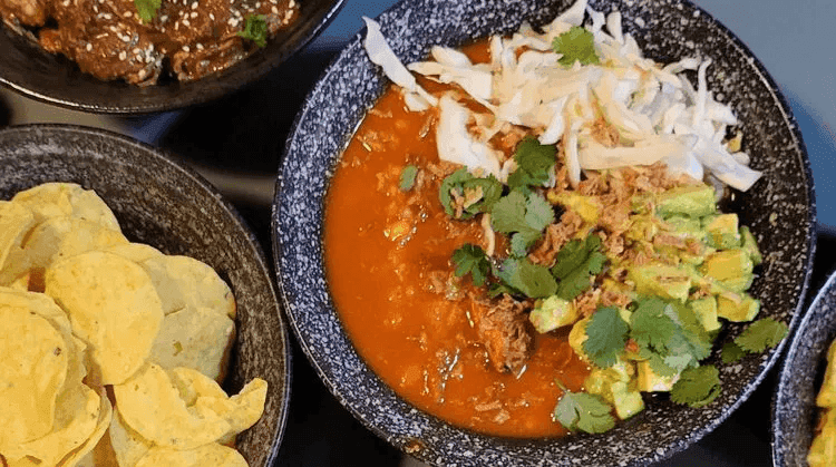 A close-up of a plate containing pork pozole.