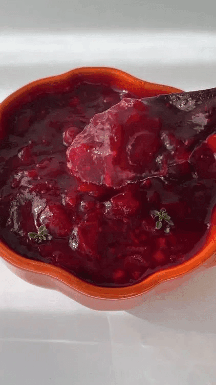 A close-up of freshly made cranberry sauce in a bowl.